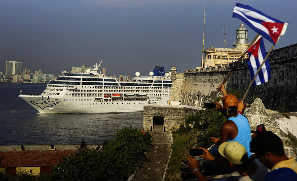 People waving Cuban flags greet Carnival’s Adonia cruise ship as it arrives in Havana in May 2016. (Photo: Ramon Espinosa/AP)