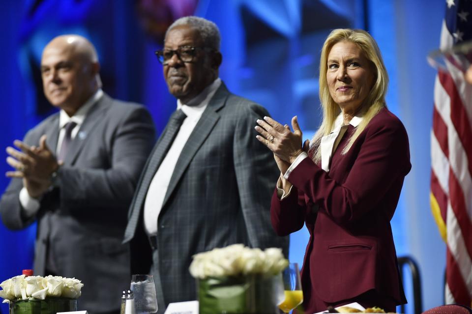 Jacksonville Mayor Donna Deegan applauds during this year's united Martin Luther King Jr. Breakfast with Patrick Geraghty, president and CEO of Florida Blue, from left, and Isaiah Rumlin, president of Jacksonville branch of the NAACP.