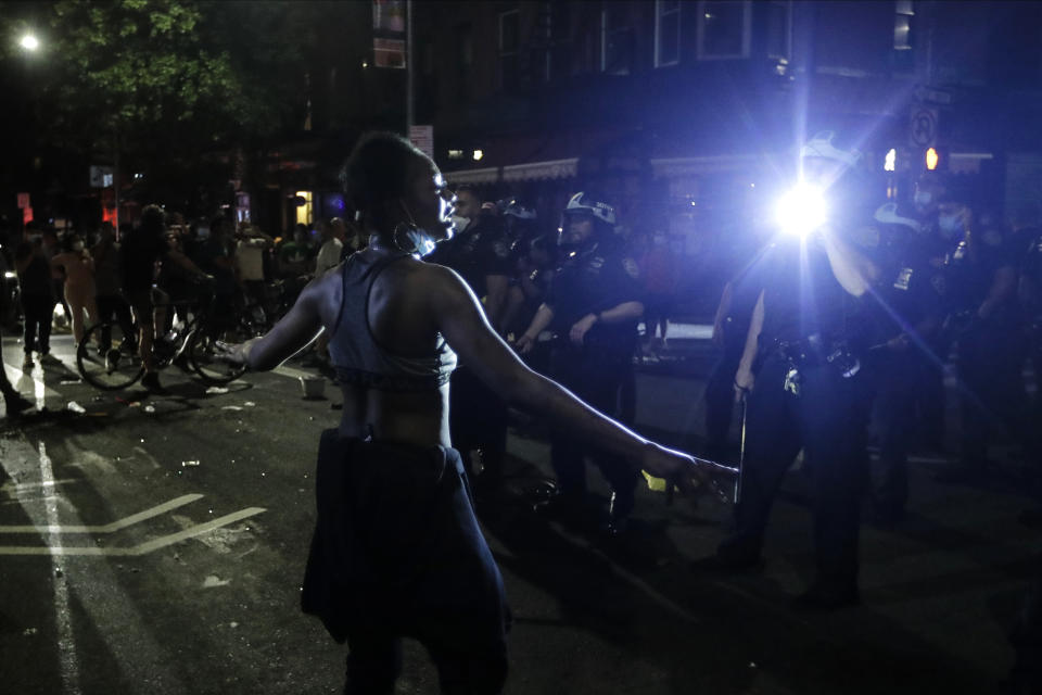 Police officers face off with protestors near Barclays Center after a rally over the death of George Floyd, a black man who was in police custody in Minneapolis Friday, May 29, 2020, in the Brooklyn borough of New York. Floyd died after being restrained by Minneapolis police officers on Memorial Day. (AP Photo/Frank Franklin II)