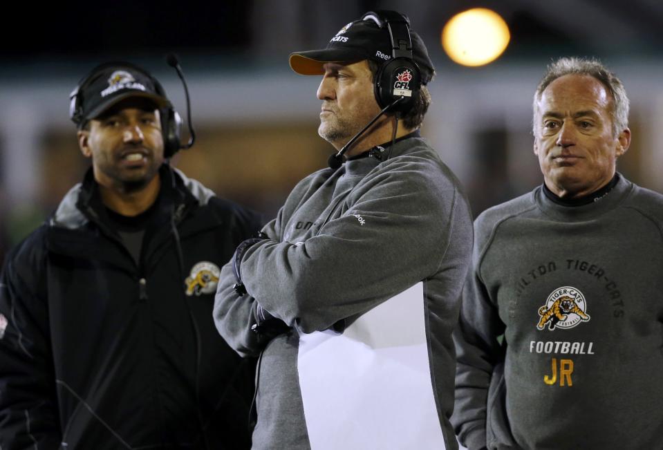 Hamilton Tiger-Cats head coach Kent Austin (C) stands with his coaches on the sideline during play against the Hamilton Tiger-Cats during the first half of the CFL's 101st Grey Cup championship football game in Regina, Saskatchewan November 24, 2013. REUTERS/Mark Blinch (CANADA - Tags: SPORT FOOTBALL)