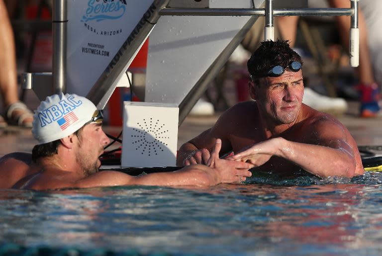 Ryan Lochte (R) is congratulated by Michael Phelps after winning the 100m butterfly final at the Arena Grand Prix in Mesa, Arizona on April 24, 2014