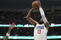 Los Angeles Clippers forward Paul George (13) shoots a 3-point basket during the first half of Game 4 of an NBA basketball first-round playoff series against the Dallas Mavericks, Sunday, April 28, 2024, in Dallas. (AP Photo/Jeffrey McWhorter)