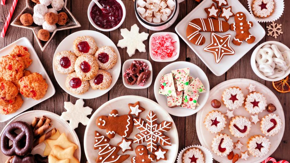 Christmas table scene of assorted sweets and cookies.