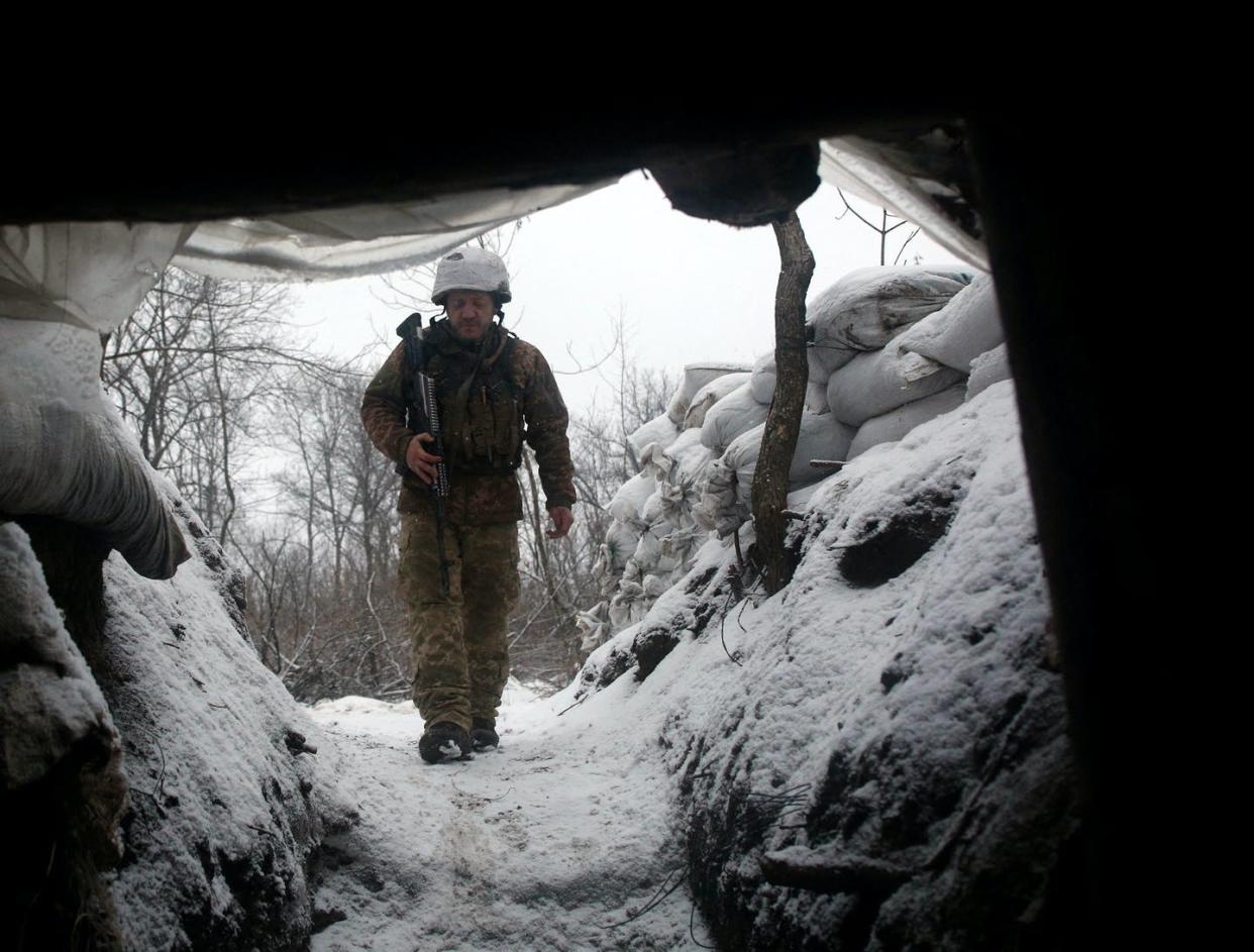 <span class="caption">A Ukrainian military serviceman walks along a snow-covered trench in the eastern Lugansk region on Jan. 21, 2022.</span> <span class="attribution"><a class="link " href="https://www.gettyimages.com/detail/news-photo/an-ukrainian-military-forces-serviceman-walks-along-a-snow-news-photo/1237904831?adppopup=true" rel="nofollow noopener" target="_blank" data-ylk="slk:Photo by Anatolii Stepanov/AFP via Getty Images;elm:context_link;itc:0;sec:content-canvas">Photo by Anatolii Stepanov/AFP via Getty Images</a></span>