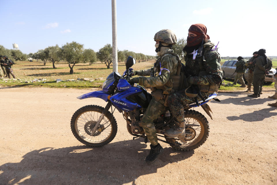 Turkish backed rebel fighters prepare for an attack near the village of Neirab in Idlib province, Syria, Thursday, Feb. 20, 2020. Two Turkish soldiers were killed Thursday by an airstrike in northwestern Syria, according to Turkey's Defense Ministry, following a large-scale attack by Ankara-backed opposition forces that targeted Syrian government troops. (AP Photo/Ghaith Alsayed)