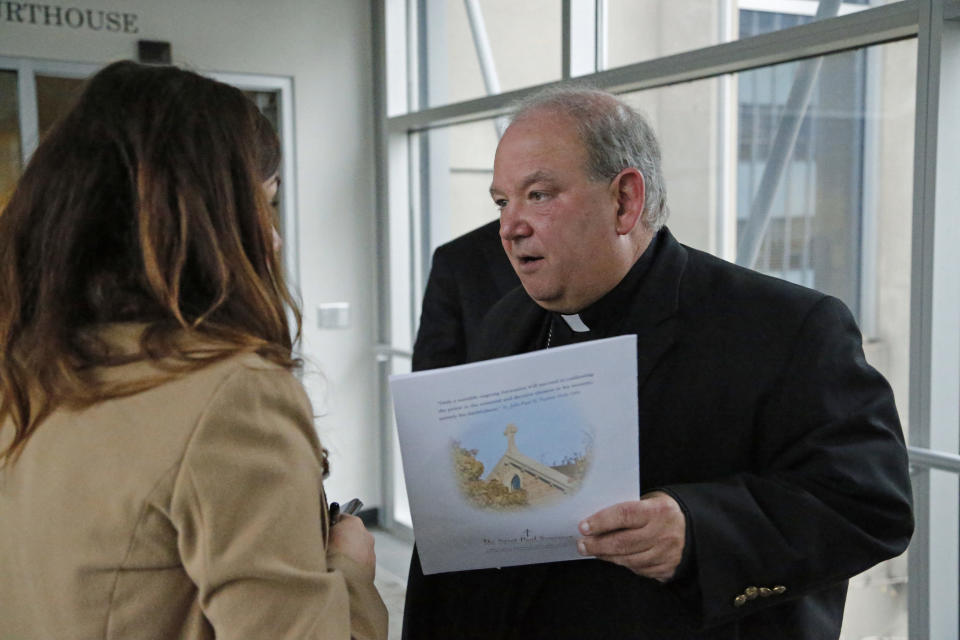 Archbishop Bernard Hebda speaks to a woman after a U.S. Bankruptcy Court approved a settlement that includes $210 million for victims of clergy sex abuse Tuesday, Sept. 25, 2018, in Minneapolis. A U.S. Bankruptcy Court judge has approved a reorganization plan for the Archdiocese of St. Paul and Minneapolis that will compensate victims of clergy sex abuse. Hundreds of victims voted overwhelmingly in favor of the plan. (Shari L. Gross/Star Tribune via AP)