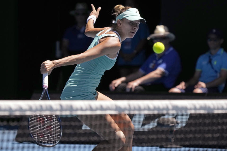 Magda Linette of Poland plays a backhand return to Caroline Garcia of France during their fourth round match at the Australian Open tennis championship in Melbourne, Australia, Monday, Jan. 23, 2023. (AP Photo/Aaron Favila)