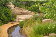 <p> When thinking about wildlife garden ideas, take a cue from the natural landscape. This RHS-gold-medal-winning garden, designed by Helen Elks-Smith, is inspired by the landscape of Yorkshire, UK and makes a stunning example. </p> <p> A gently flowing water feature curves through pockets of naturalistic planting, whilst harder landscaping features, including a dry stone wall, are made from local stone.&#xA0; </p> <p> The scene is reminiscent of the meadows and woodlands of the wider natural environment and will welcome all manner of birds, bees, butterflies, and other creatures. However, it&apos;s perfectly balanced and still feels contemporary, so is sure to be loved by people, too. </p>