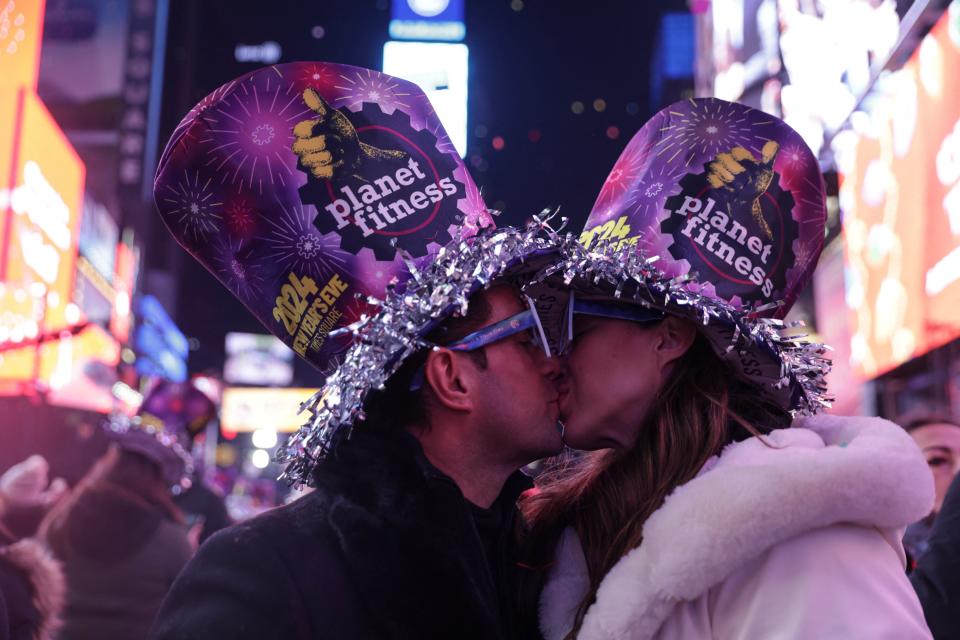 A couple kiss after the clock strikes midnight during New Year celebrations at Times Square, in New York City, New York, US, 1 January 2024 (Reuters)