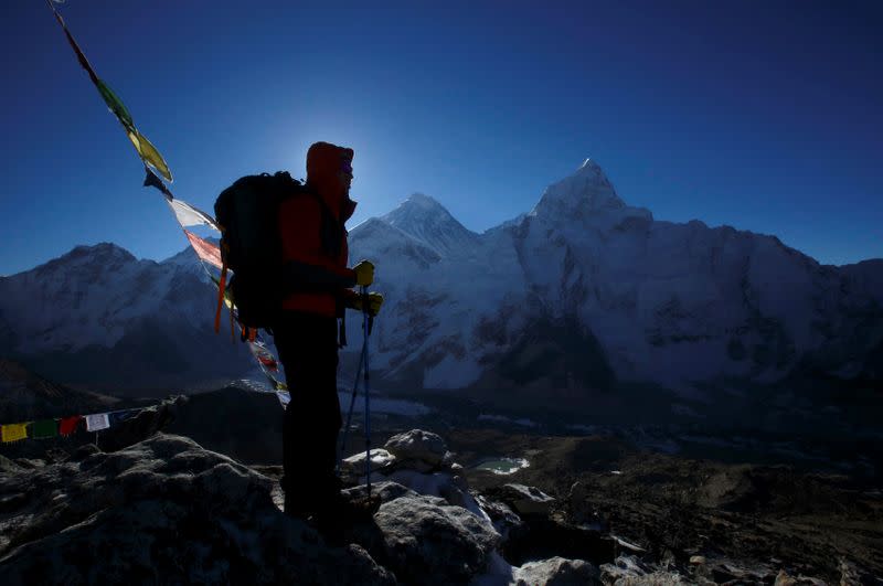 A trekker stands in front of Mount Everest at Kala Patthar in Solukhumbu District