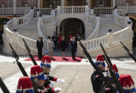 From left to right, Chinese President Xi Jinping, his wife Peng Liyuan, Prince Albert II of Monaco's wife, Princess Charlene and Prince Albert II of Monaco review the honor guards during a welcome ceremony at Monaco Palace, Sunday, March 24, 2019. Xi is paying the first state visit by a Chinese president to the tiny Mediterranean principality of Monaco on Sunday. (AP Photo/Olivier Anrigo)