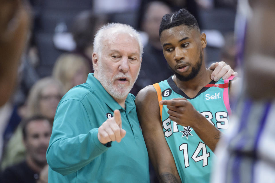 San Antonio Spurs head coach Gregg Popovich counsels guard Blake Wesley (14) during the first quarter of an NBA basketball game against the Sacramento Kings in Sacramento, Calif., Sunday, April 2, 2023. (AP Photo/Randall Benton)