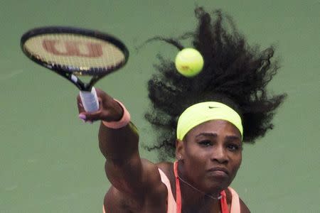 Serena Williams of the U.S. serves to Kiki Bertens of the Netherlands during their second round match at the U.S. Open Championship tennis tournament in New York, September 2, 2015. REUTERS/Adrees Latif