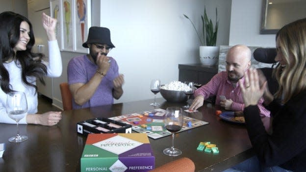 A group of people play the updated version of Personal Preference.