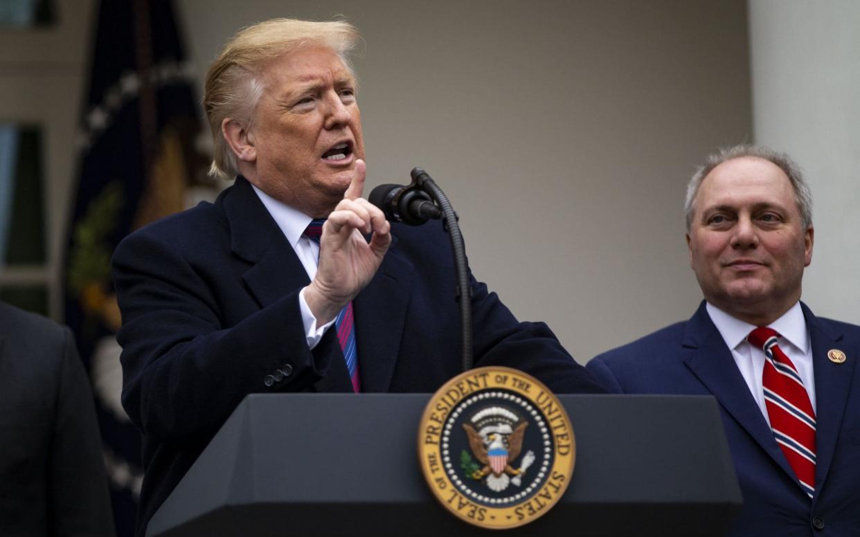 U.S. President Donald Trump speaks while House Minority Whip Steve Scalise, a Republican from Louisiana, right, listens  - Bloomberg