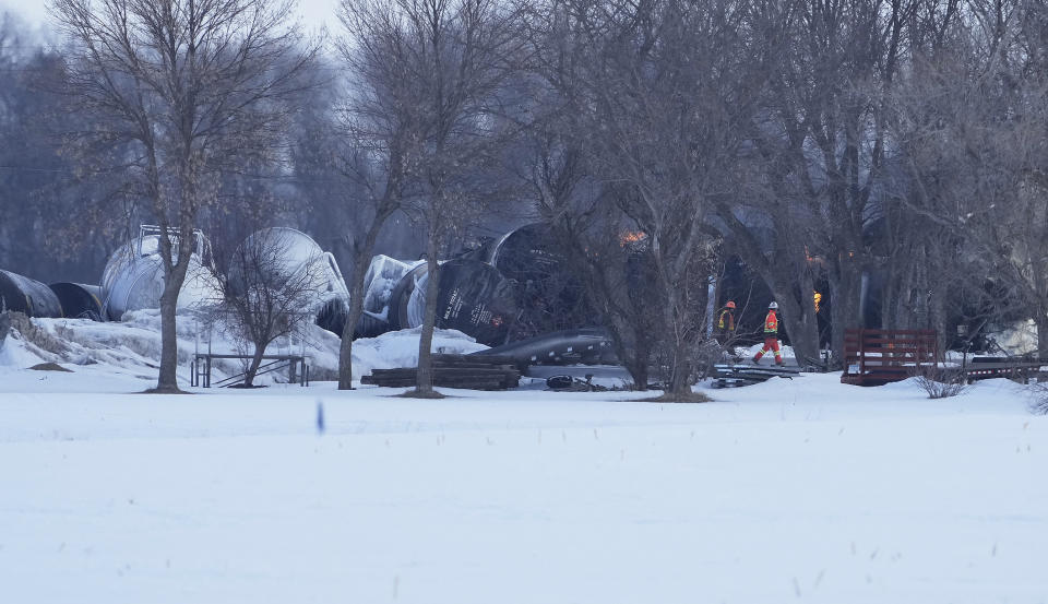 Emergency personnel respond to the scene after a BNSF train derailed in Raymond, Minn., Thursday, March 30, 2023. The train hauling ethanol and corn syrup derailed and caught fire early Thursday and nearby residents were ordered to evacuate their homes, authorities said.(David Joles /Star Tribune via AP)
