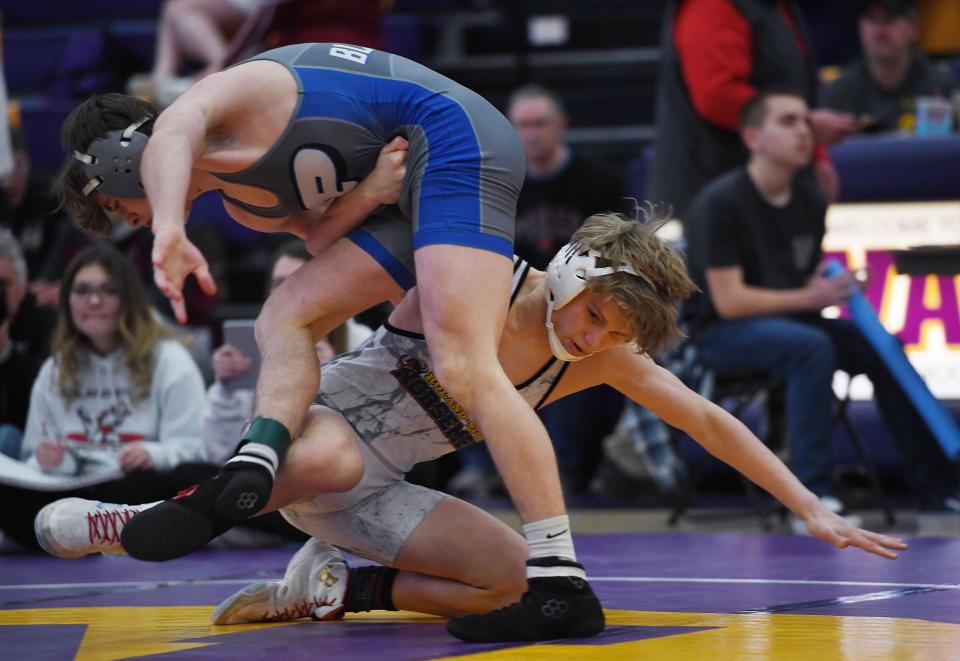 Roland-Story's Logan Power takes down Perry's Cole Nelson during their 138-pound wrestling final in the HOI Conference  wrestling tournament at Nevada High School Friday, Jan. 21, 2022, in Nevada, Iowa.