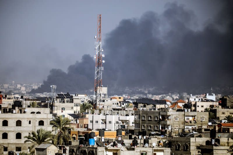 Back smoke billows from Khan Younis in the southern Gaza Strip during Israeli bombardment of the city on Wednesday. Photo by Ismael Mohamad/UPI