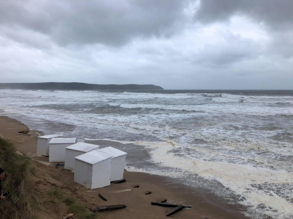 Several beach huts being washed into the sea as heavy winds battered Britain. See SWNS story SWPLhuts SWPLhuts; The huts washed into the sea at Woolacombe beach last night (Thurs) and were still bobbing around with the waves this morning 21 Aug 2020. Local resident Richard Walden said it was a scene of devastation. His pictures were taken as Britain woke up to the carnage caused by the arrival of Storm Ellen. The Met Office predicted wind gusts reaching speeds of over 50mph in places.