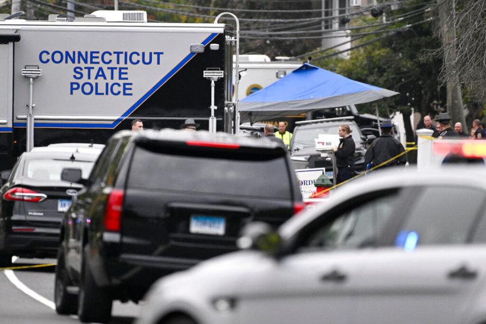 Members of the Connecticut State Police Major Crime unit are on scene where two police officers killed, Thursday, Oct. 13, 2022, in Bristol, Conn. Two police officers were fatally shot and a third wounded while responding to a domestic violence call in Connecticut, authorities said Thursday, amid an exceptionally violent week for officers across the country.