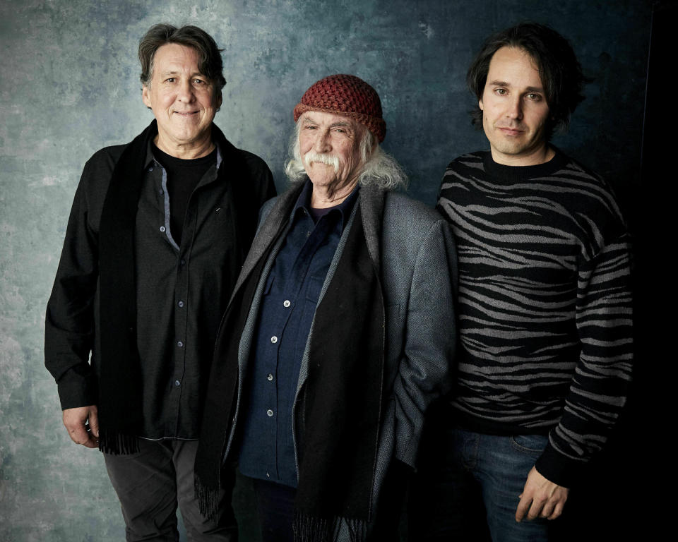 FILE - In this Jan. 26, 2019 photo, producer Cameron Crowe, from left, David Crosby and director A.J. Eaton pose for a portrait to promote the film "David Crosby: Remember My Name" at the Salesforce Music Lodge during the Sundance Film Festival in Park City, Utah. Crosby has turned down repeated offers to do a biopic, but said yes to doing a documentary with Crowe's involvement that examines his turbulent life. The film opens in limited release on Friday, July 19, 2019, and includes the rocker's candid reflections on his career, relationships and feuds. (Photo by Taylor Jewell/Invision/AP, File)