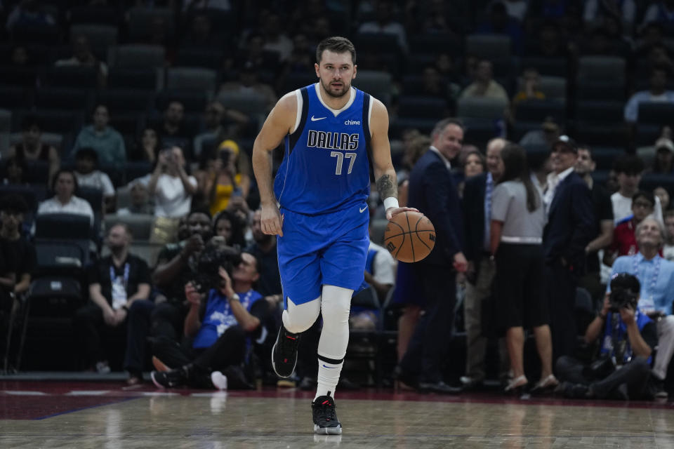 Luka Doncic of Dallas Mavericks dribbles during a preseason NBA basketball game between the Dallas Mavericks and Minnesota Timberwolves in Abu Dhabi, United Arab Emirates, Thursday, Oct. 5, 2023. (AP Photo/Kamran Jebreili)