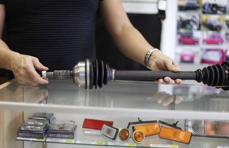 Rafael Lamela holds a drive shaft, part for the Lada car, in Fabian Zakharov's Zakharov Auto Parts in Hialeah, Florida, February 4, 2015. REUTERS/Javier Galeano