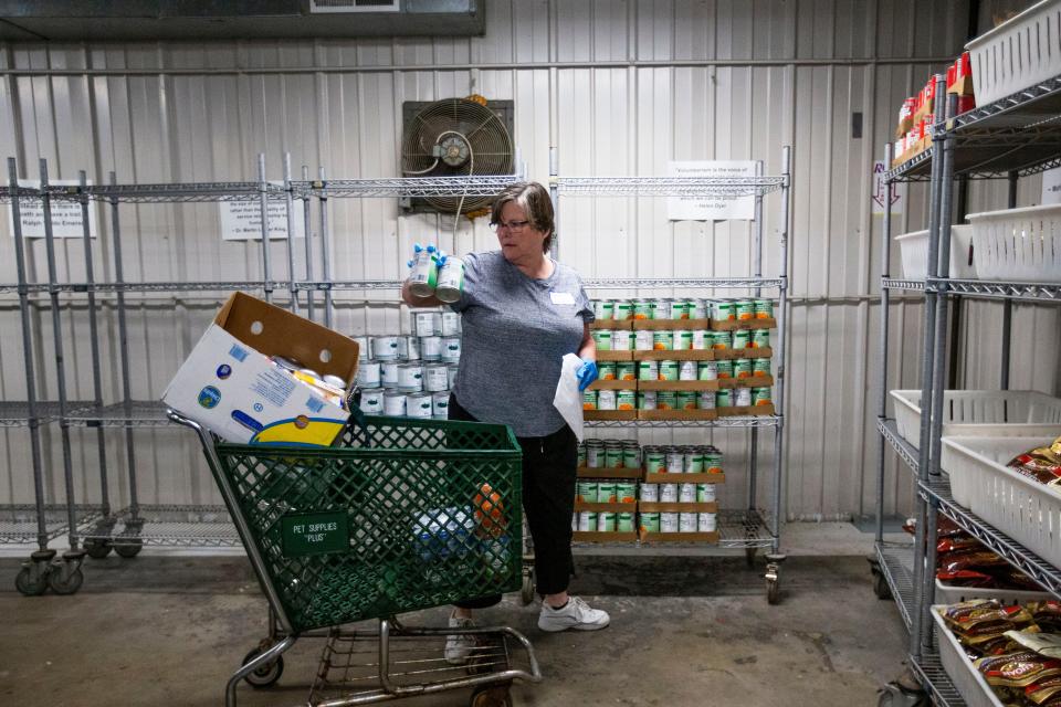Eileen Dial packs up food for distribution Wednesday, May 18, 2022, at the Food Bank of Northern Indiana in South Bend.