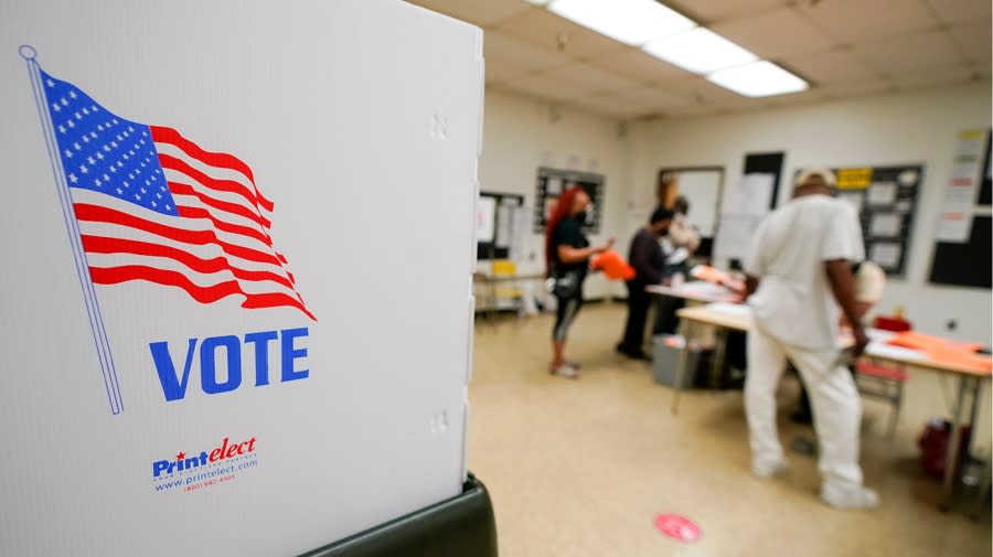 People check in to vote at Edmondson Westside High School during Maryland’s primary election, Tuesday, July 19, 2022, in Baltimore. (AP Photo/Julio Cortez)