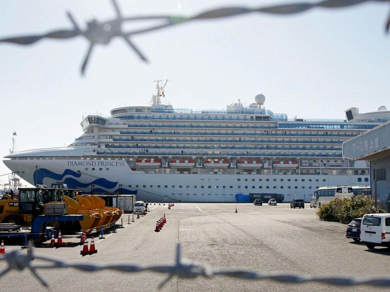 The quarantined ship Diamond Princess is pictured through barbed wire at Yokohama port in Yokohama, near Tokyo: AP