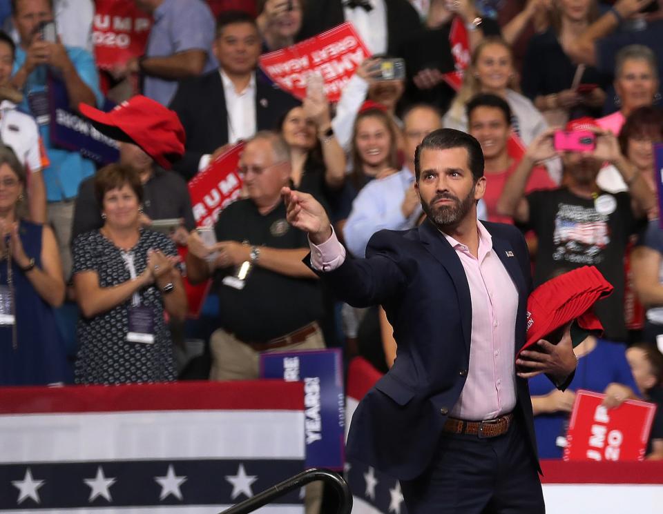 Donald Trump Jr. tosses campaign hats to the crowd before his father, U.s. President Donald Trump arrives on stage to announce his candidacy for a second presidential term at the Amway Center on June 18, 2019 in Orlando, Florida.