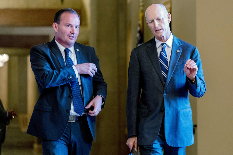 Sen. Mike Lee, R-Utah, left, and Sen. Rick Scott, R-Fla., right, walk out of a meeting in the office of Senate Minority Leader Mitch McConnell of Ky. as the $1 trillion bipartisan infrastructure bill gets closer to passage in Washington, Monday, Aug. 9, 2021. (AP Photo/Andrew Harnik)