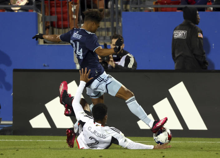 Dallas defender Geovane Jesus (2) tries to get the ball away from Sporting Kansas City defender Kayden Pierre (24) in the second half of an MLS soccer match, Saturday, March 18, 2023, in Frisco, Texas. (AP Photo/Richard W. Rodriguez)