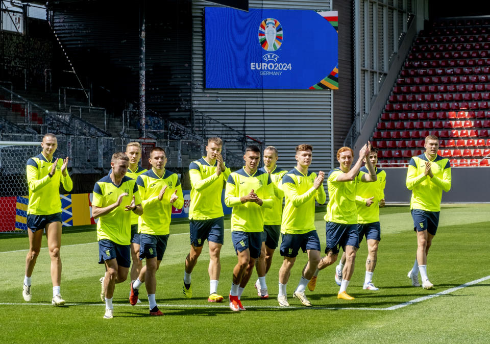 Players of Ukraine's national soccer team warm up during a public training session in Wiesbaden, Germany, Thursday, June 13, 2024, ahead of their group E match against Romania at the Euro 2024 soccer tournament. (AP Photo/Michael Probst)