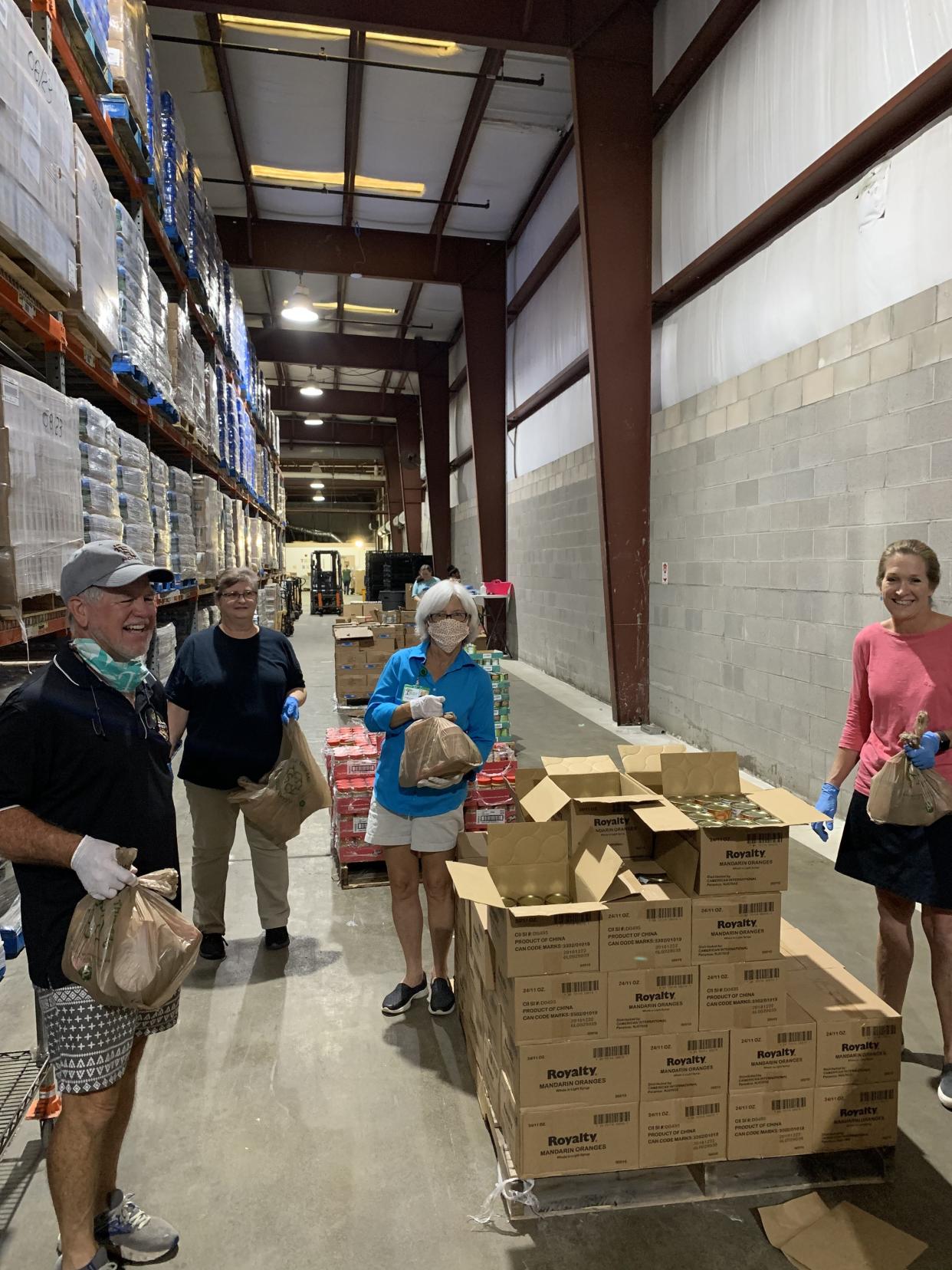 The McKibbens join other community volunteers to prepare food bags for distribution at Second Harvest of the Big Bend.