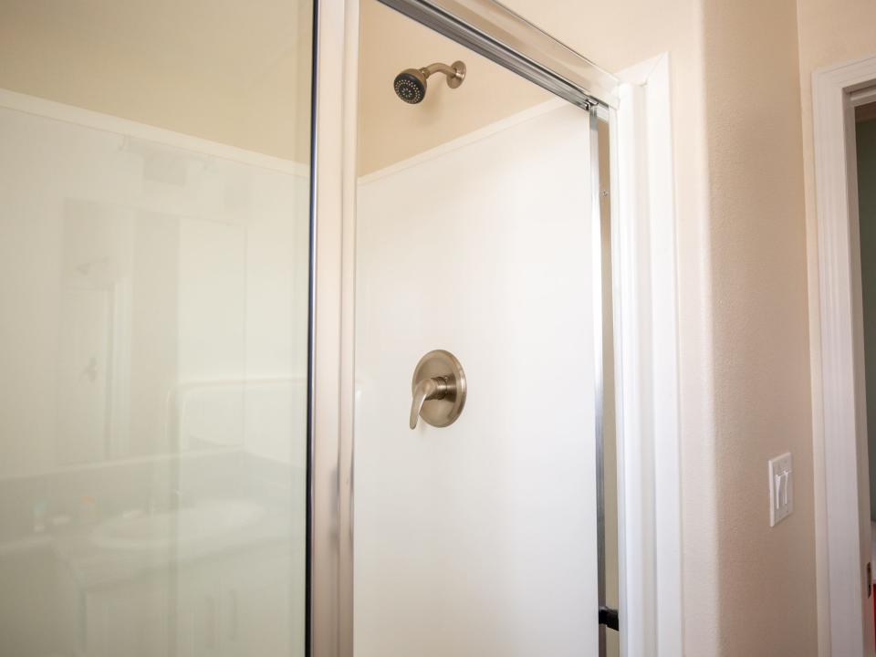A shower with a glass door.