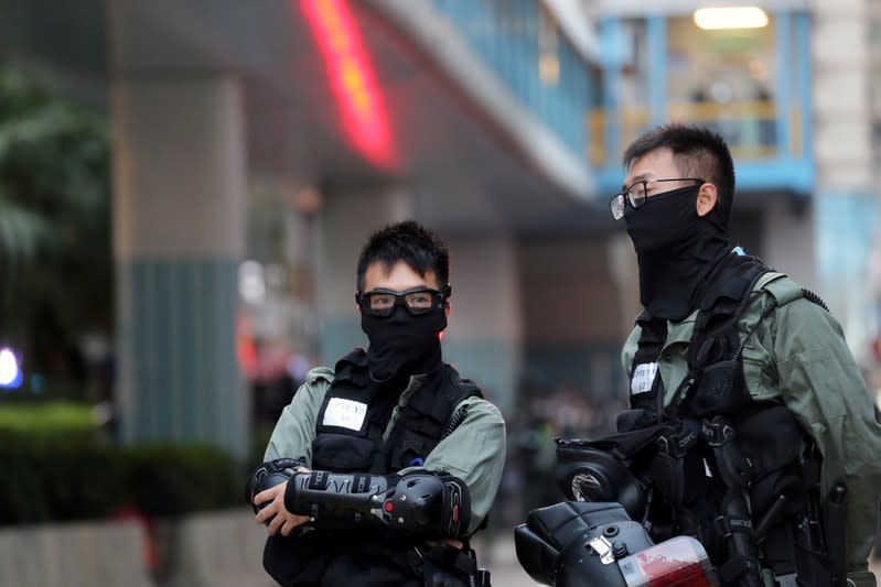 Police officers stand inside the campus of the Polytechnic University (PolyU) in Hong Kong