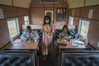 From left, Sibonino Nene, head of vaccination program, Ntombekhaya Kondile, data capturer, and Transvaco Manager Dr. Paballo Mowana have lunch aboard the COVID-19 vaccination train parked at the Swartkops railroad yard outside Gqeberha, South Africa, Thursday Sept. 23, 2021. South Africa has sent a train carrying COVID-19 vaccines into one of its poorest provinces to get doses to areas where healthcare facilities are stretched. The vaccine train, named Transvaco, will go on a three-month tour through the Eastern Cape province and stop at seven stations for two weeks at a time to vaccinate people. (AP Photo/Jerome Delay)