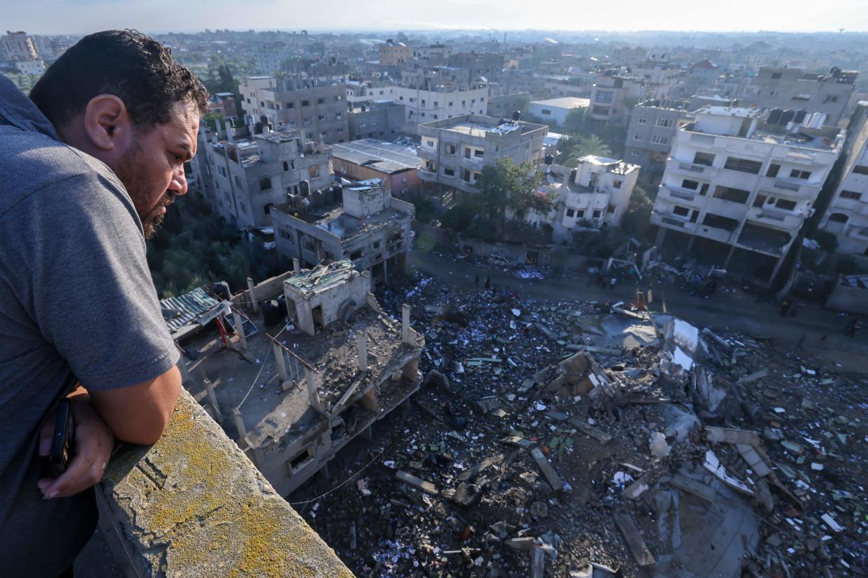  A Palestinian man looks a building destroyed in an Israeli airstrike in the Rafah refugee camp in the southern of Gaza Strip on October 16 2023 Israel declared war on the Islamist group Hamas on October 8 a day after waves of its fighters broke through the heavily fortified border and killed more than 1400 people most of them civilians The relentless Israeli bombings since have flattened neighbourhoods and left at least 2670 people dead in the Gaza Strip the majority ordinary Palestinians Photo by MOHAMMED ABED  AFP Photo by MOHAMMED ABEDAFP via Getty Images. 