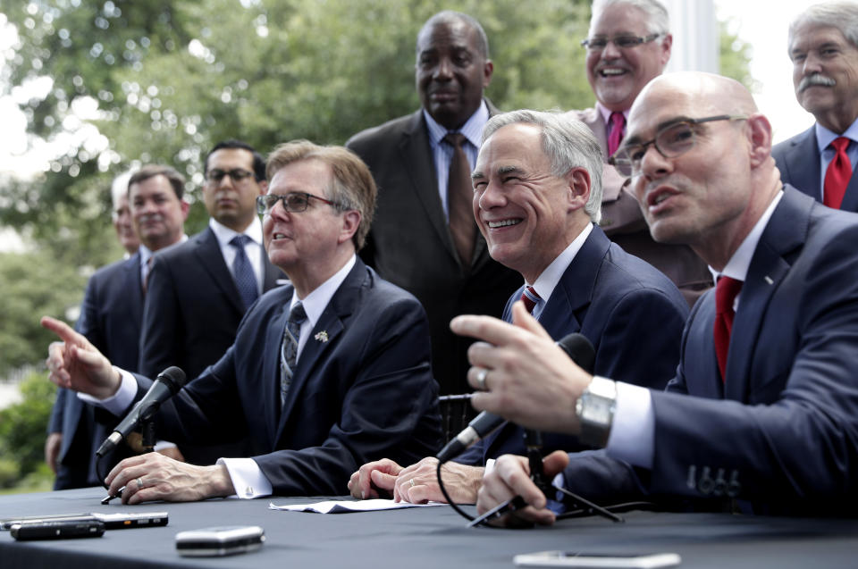 Governor Greg Abbott, seated center, Lt. Governor Dan Patrick, seated left, and Speaker of the House Dennis Bonnen, seated right, and other law makers attend a joint press conference to discuss teacher pay and school finance at the Texas Governor's Mansion in Austin, Texas, Thursday, May 23, 2019, in Austin. (AP Photo/Eric Gay)