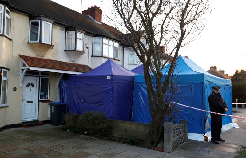 A police officer stands guard outside the home of Nikolai Glushkov in New Malden