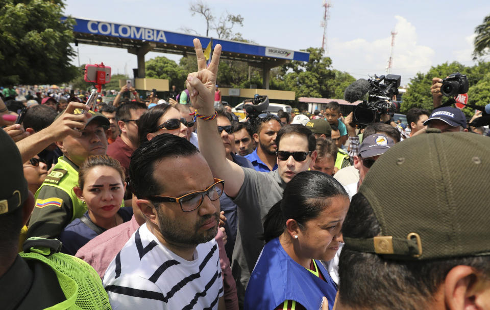 In this Sunday, Feb. 17, 2019 photo, U.S. Senator Marco Rubio, R-Fla., greets Venezuelan migrants near the Simon Bolivar International Bridge, which connects Colombia with Venezuela, in La Parada, near Cucuta, Colombia. As part of U.S. humanitarian aid to Venezuela, Rubio visited the area where the medical supplies, medicine and food aid is stored before it it expected to be taken across the border on Feb. 23. (AP Photo/Fernando Vergara)