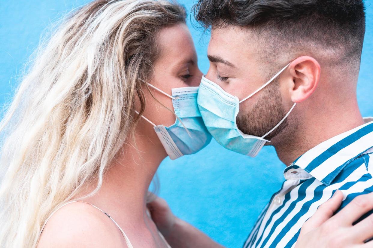 <span class="caption">Little information is available to college students on stopping the spread of COVID-19 within an intimate relationship.</span> <span class="attribution"><a class="link " href="https://www.gettyimages.com/detail/photo/young-couple-kissing-with-face-protective-mask-royalty-free-image/1265180786?adppopup=true" rel="nofollow noopener" target="_blank" data-ylk="slk:DisobeyArt/iStock via Getty Images Plus;elm:context_link;itc:0;sec:content-canvas">DisobeyArt/iStock via Getty Images Plus</a></span>