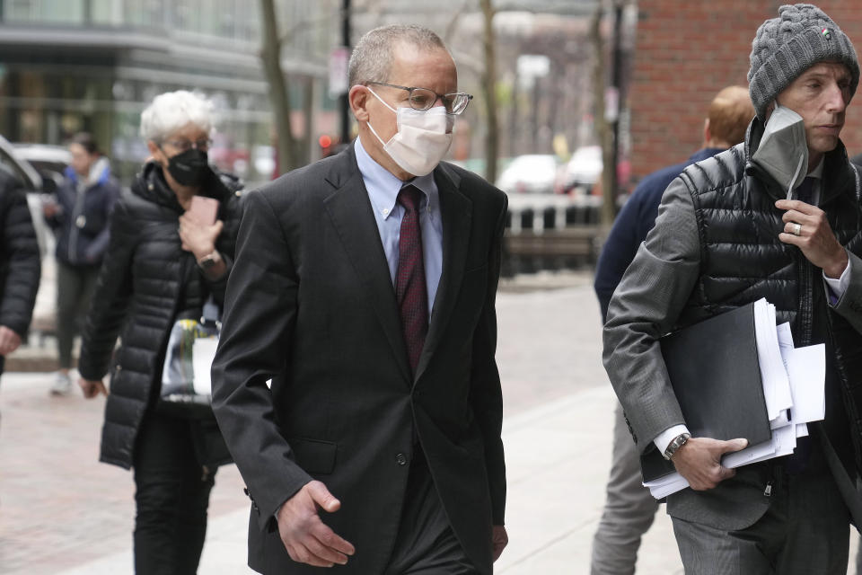 Charles Lieber, center, arrives at federal court in Boston, Wednesday, April 26, 2023. Lieber, a former Harvard University professor convicted of lying to federal investigators about his ties to a Chinese-run science recruitment program and failing to pay taxes on payments from a Chinese university, is scheduled to be sentenced Wednesday. (AP Photo/Steven Senne)