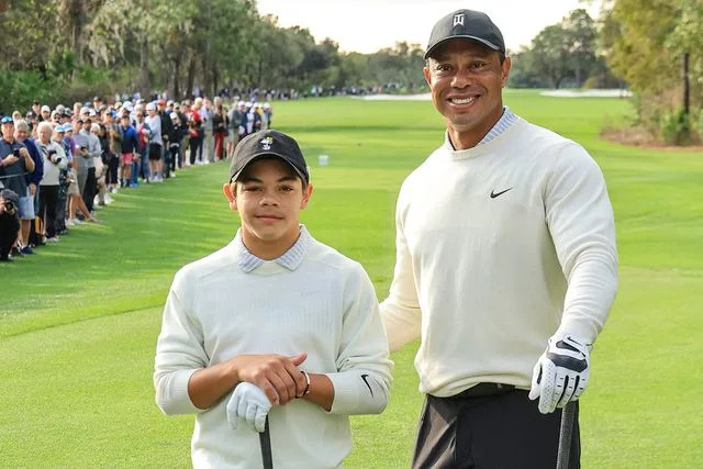 David Cannon/Getty Images Tiger Woods poses with his son Charlie Woods