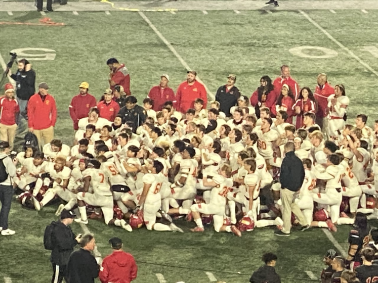 San Diego Cathedral players celebrate on the field during an award ceremony after defeating Orange Lutheran.