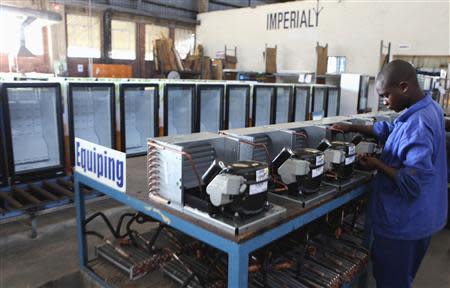 An employee works in a fridge manufacturing company in the capital Harare, November 14, 2013. REUTERS/Philimon Bulawayo