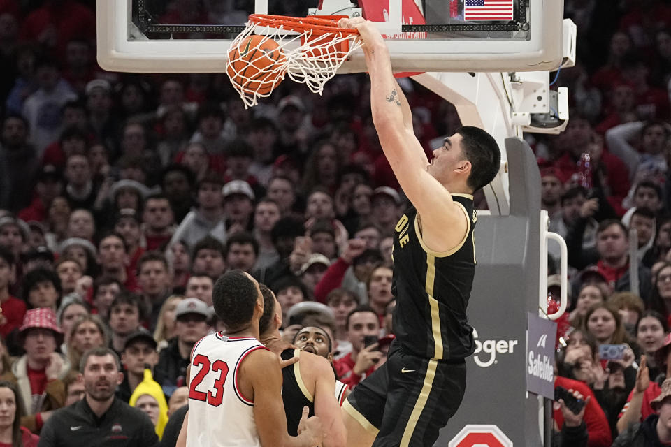 Purdue center Zach Edey, right, dunks in front of Ohio State forward Zed Key (23) in the second half of an NCAA college basketball game, Sunday, Feb. 18, 2024, in Columbus, Ohio. (AP Photo/Sue Ogrocki)