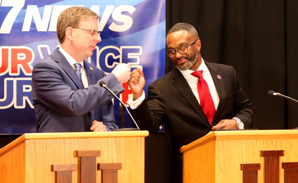 Candidates Mayor James Mueller and Common Council member Henry Davis Jr. fist bump Wednesday, March 15, 2023, after the Democratic South Bend mayoral debate at Indiana University South Bend.