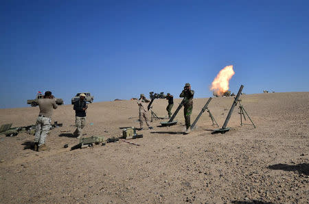 Shi'ite Popular Mobilization Forces (PMF) fire a mortar shell towards Islamic State militants' positions in Al-Al-Fateha military airport south of Hawija, Iraq, October 2, 2017. REUTERS/Stringer